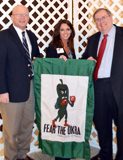 From left, Delta State Director of Communications and Marketing Michael Gann, Vice President for University Relations Dr. Michelle Roberts, and President Dr. John M. Hilpert display the banner presented as a “Student’s Choice Recognition Award” in recognition of the “Fear The Okra” campaign.  Other team members not pictured include: Graphic Designer Laura Walker, Web Content Coordinator Caitlyn Thompson, Writer/Coordinator Kimberly Cooley, Senior Secretary Bevin Lamb,  and Coordinator of Executive Services Leigh Korb. 